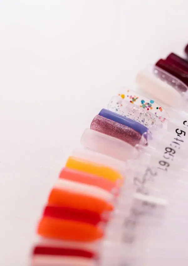 Showcasing a variety of vibrant nail polish colors on display sticks for selection.